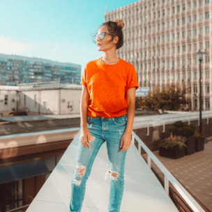 Sophie modeling outside in an orange shirt